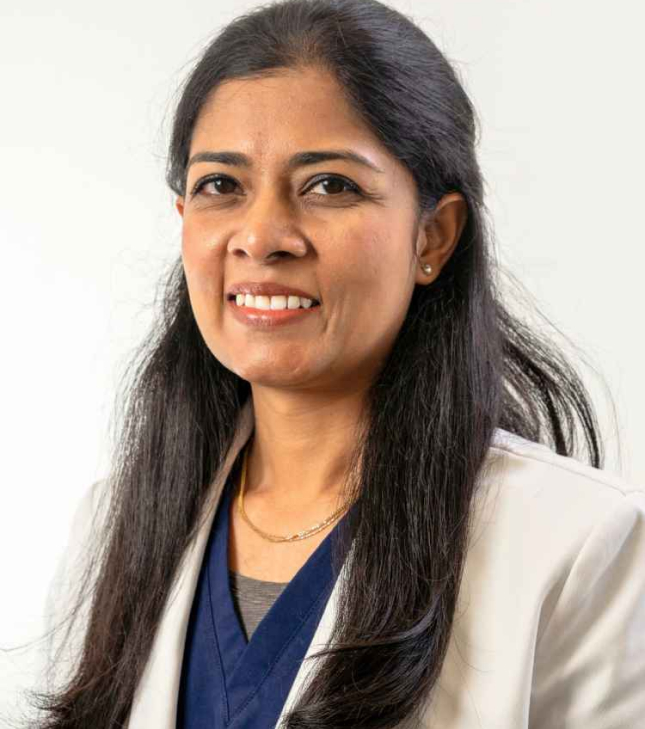 Women dentist that works at Nuvia in a white coat