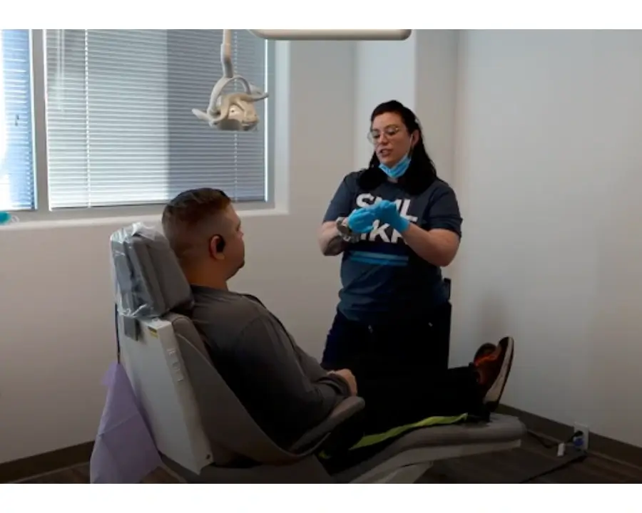 Billy in the dental chair talking to hygenist