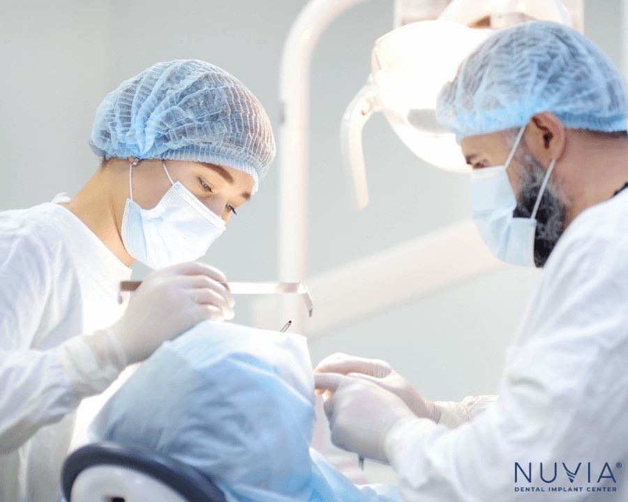 CRNA helping give patient a protected airway during dental implant surgery