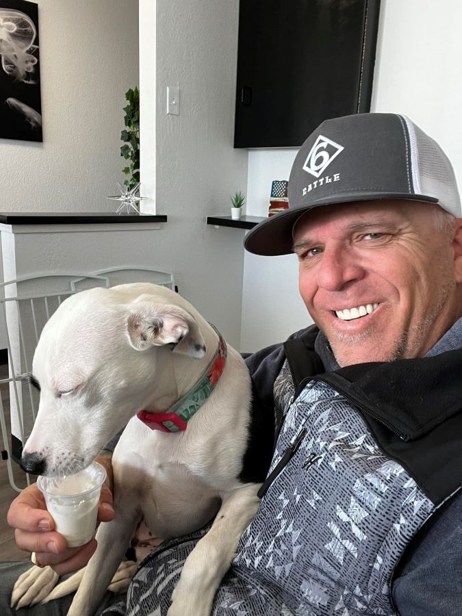 Dennis with his dog after the side effects of dental implants
