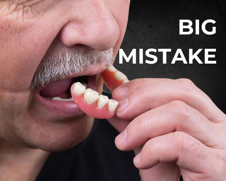 Man placing bottom dentures in mouth