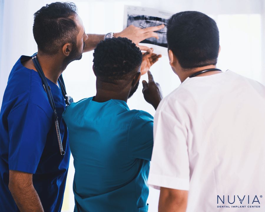 Team of dentists evaluating patient because of their diabetes and dental implants request