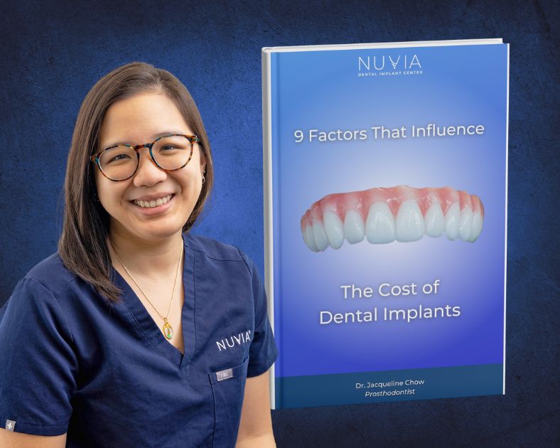 Dr Chow next to book about the cost of full mouth dental implants