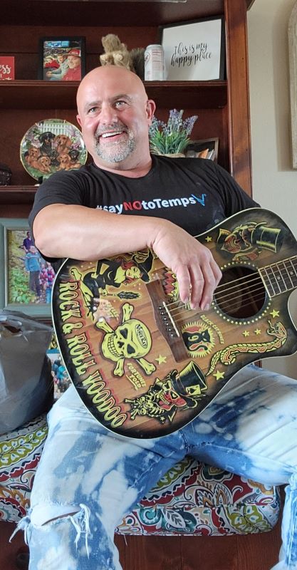 Chris with guitar after smile restoration