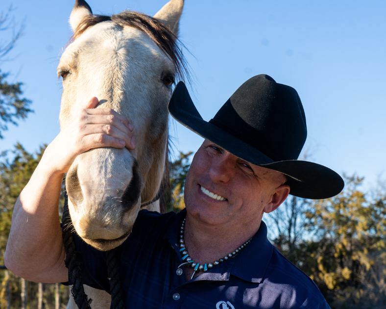 Ricky with his permanent artificial teeth and horse