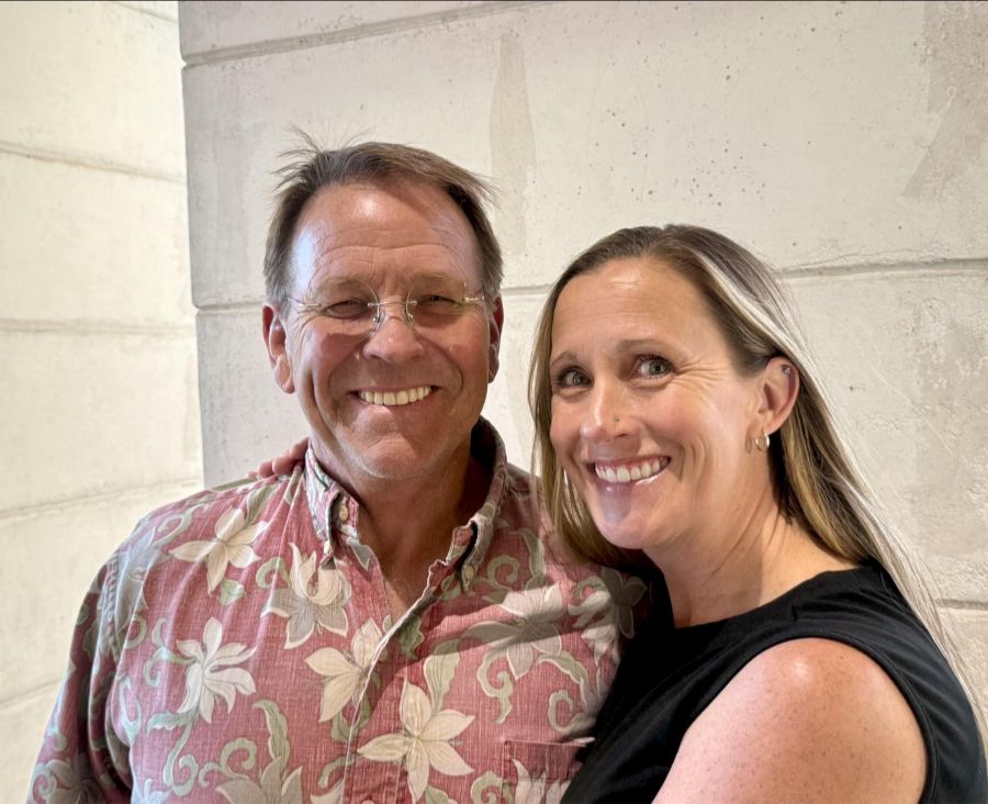husband and wife smiling with their full mouth dental implants