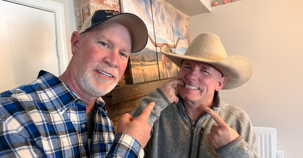 Troy pointing to ricky's smile with dental implants