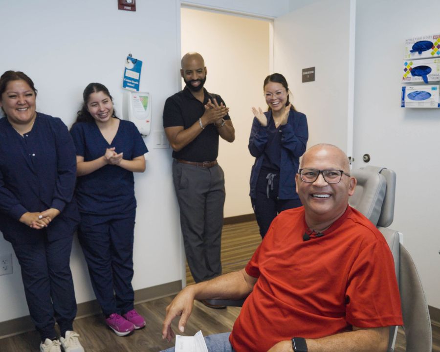 Clapping Nuvia team smiling with patient