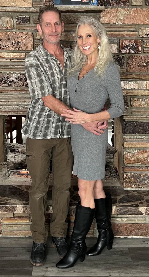 Dental implant patient smiling with her husband