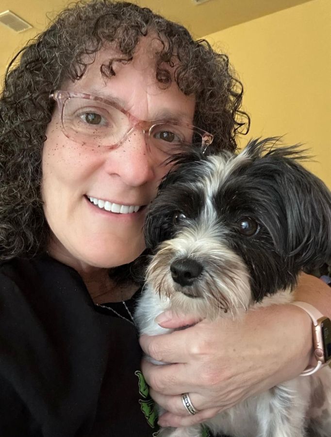 Cynthia smiling with her dog