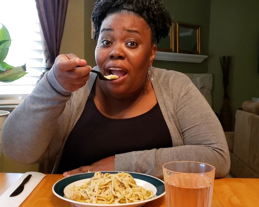 Dental implant patient eating dinner with her dental implants