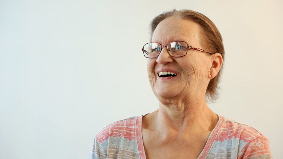 Frances smiling after getting dental implants despite bone loss in the jaw