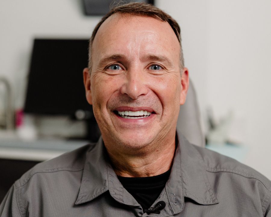 Mike smiling after getting his botched dental implants fixed