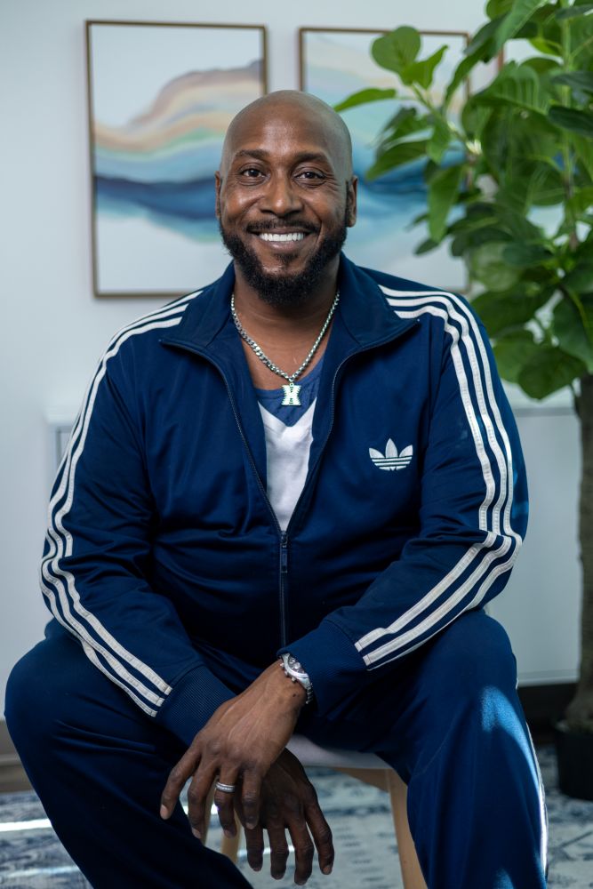 Bishop smiling at the camera with his new teeth