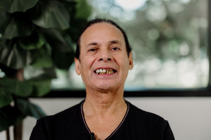 Pedro smiling after dental tourism with failing teeth